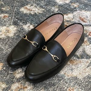 Coach black loafers with a gold horsebit